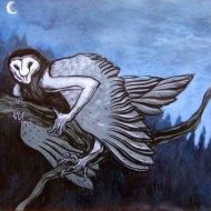 silhouette of Strix perched on a branch