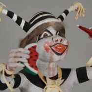 Close-up of Koshari makeup and feather adornments