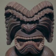 Close-up of a mythological creature with wings and a horn.