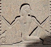 Carving of "Heh, god of infinity often shown holding palm fronds of time."