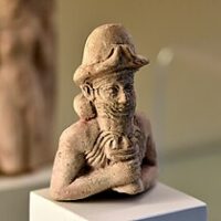"Bust of Enki, the God of Wisdom, showing his head and upper torso with detailed facial features."