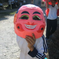 Mask representing Ong Dia, the Earth God, featuring stylized facial features.