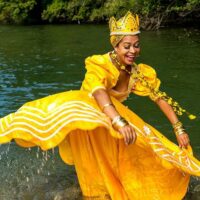Cosplay of Oshun, artist portraying the goddess of love in costume.