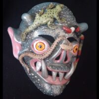 Representation of Anchanchu with a lizard resting on its head