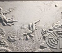 Wall carving of Icarus, the tragic fugitive attempting flight.