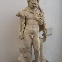 Stone statue of Nodens depicted with oceanic motifs.