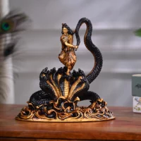 A figurine of Krishna dancing on the head of Kaliya Naag
