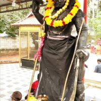 An idol of Sudalai Madan being worshipped
