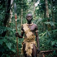 Mekuku, the heroic warrior of Fang mythology, depicted as a tall, muscular Central African figure standing in a dense equatorial forest.